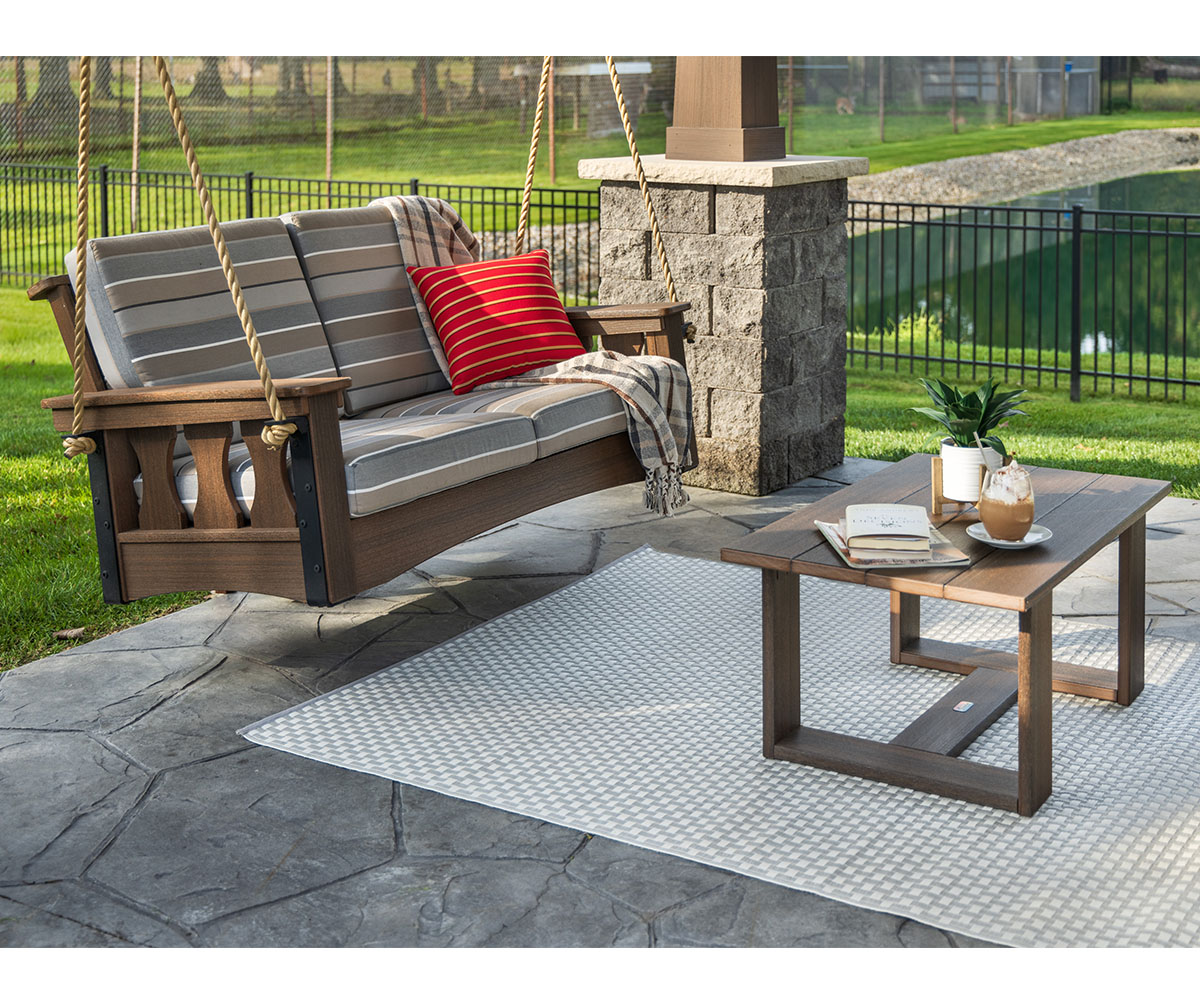 What is the best outdoor furniture? Cushioned porch swing and patio table by pool.