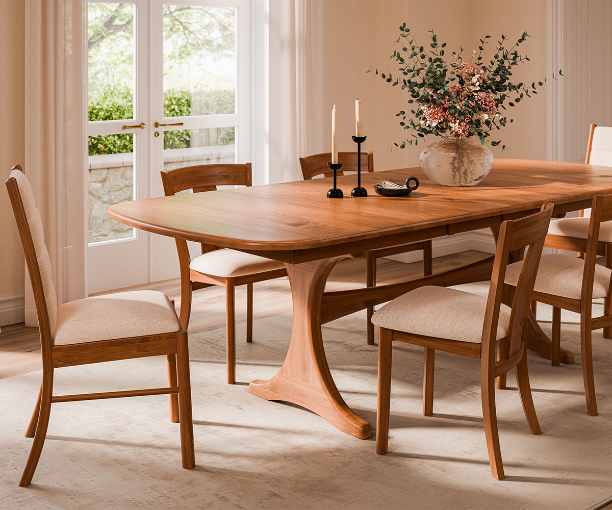 Solid wood trestle dining table with six chairs, light rug, airy room.