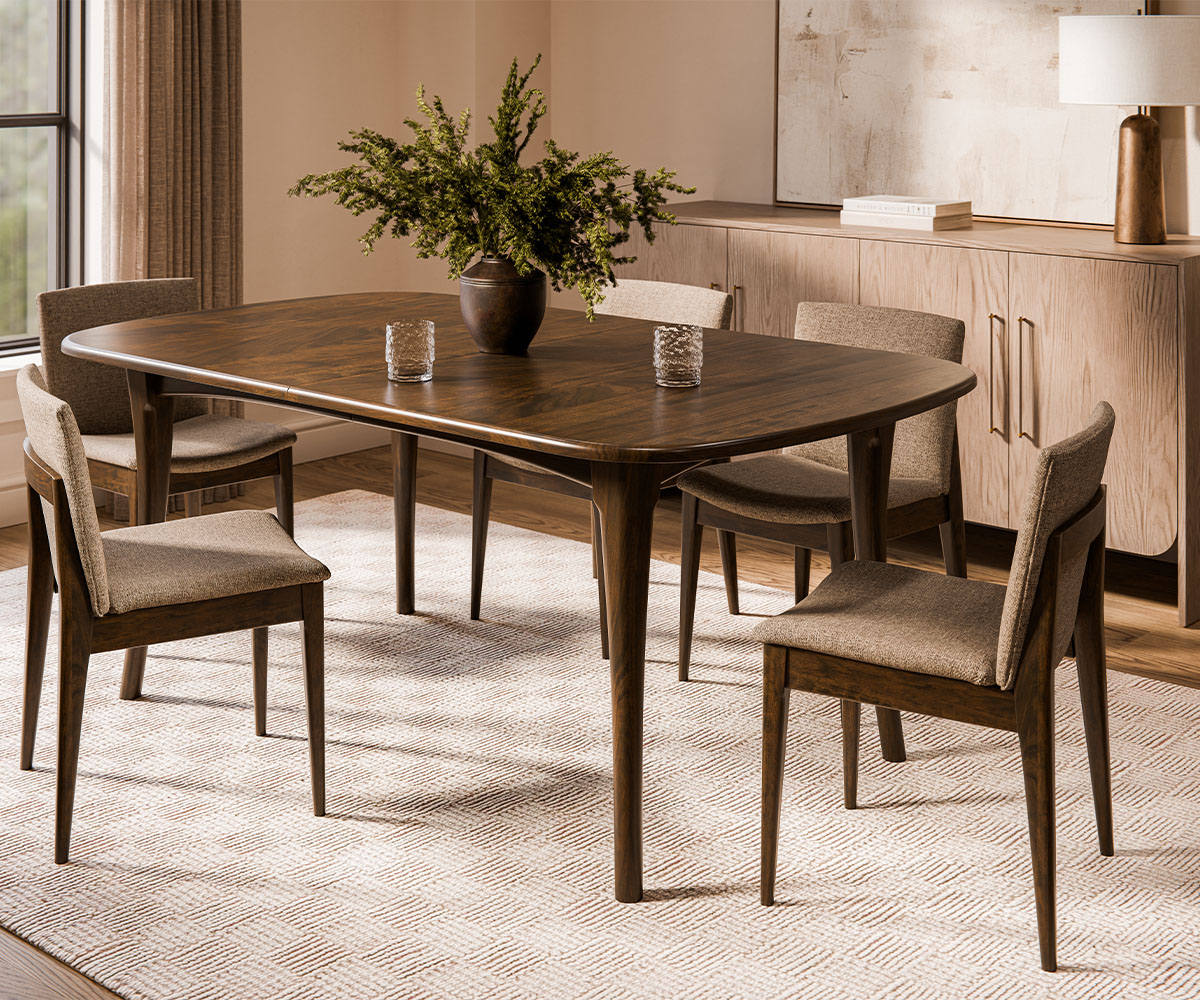 Modern dining room furniture—rectangular wood table with tapered legs and four upholstered chairs.