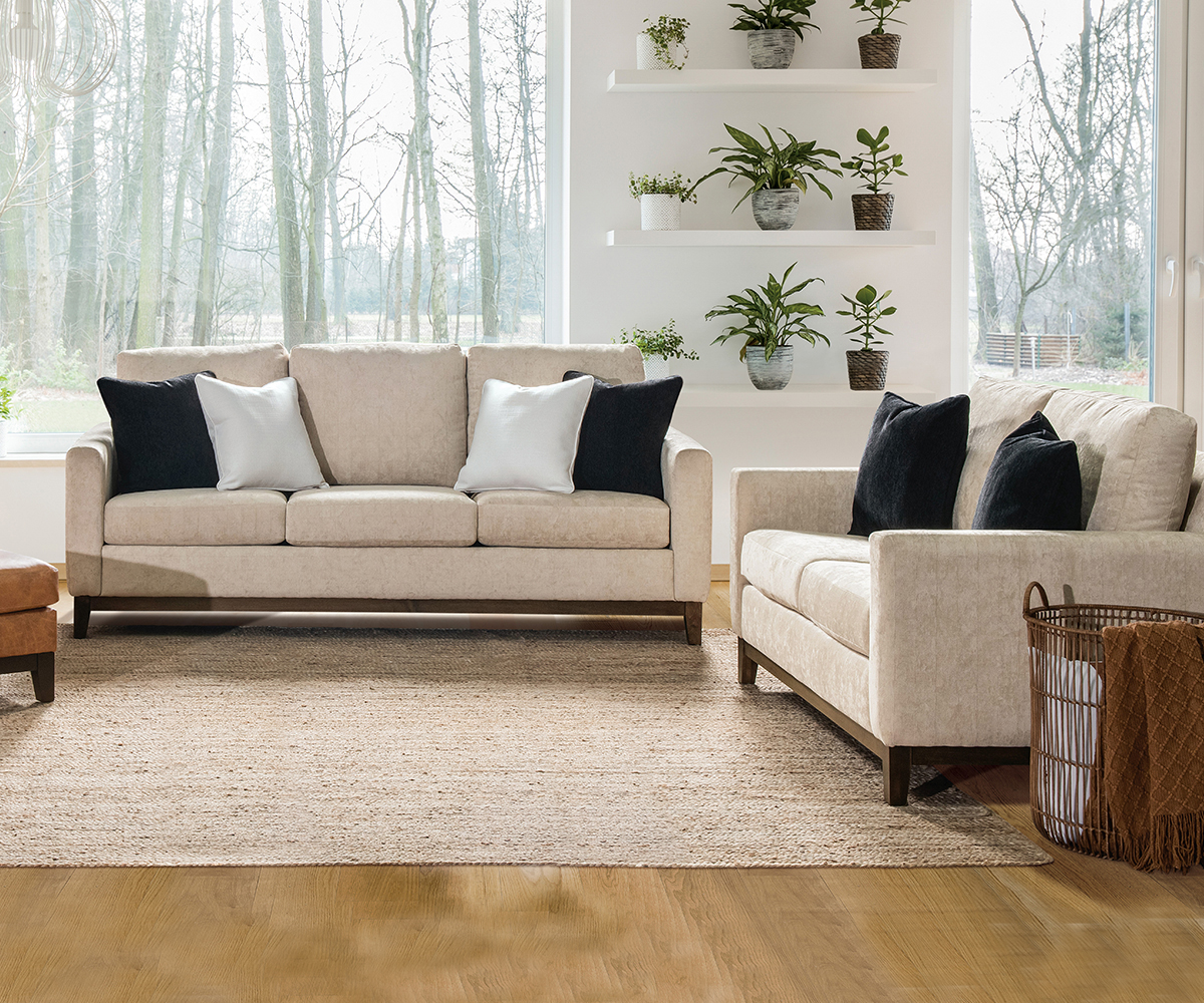 Neutral sofa set—living room furniture with wood bases and contrast pillows.