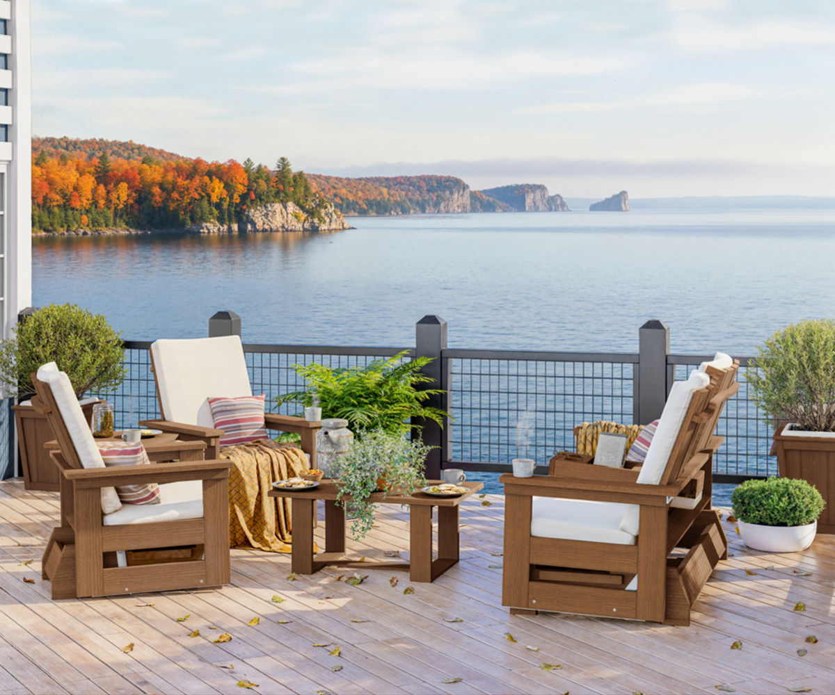 Poly vs wood furniture patio set on lakeside deck with cushioned chairs and table.